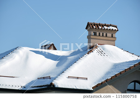 Snow guard for safety in winter on house roof top covered with steel shingles. Tiled covering of building 115800758