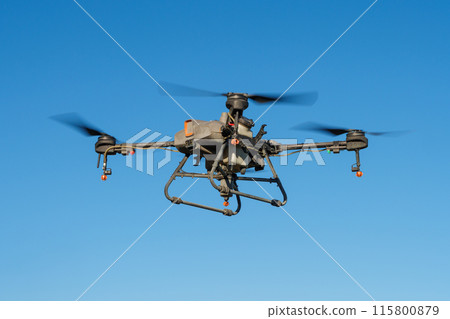 Agricultural pesticide sprayer drone flying in the air 115800879