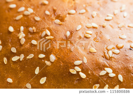 Extreme close-up shot of a sesame seed bun 115800886