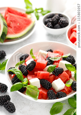 Watermelon salad with feta cheese, blackberry and fresh basil 115801057