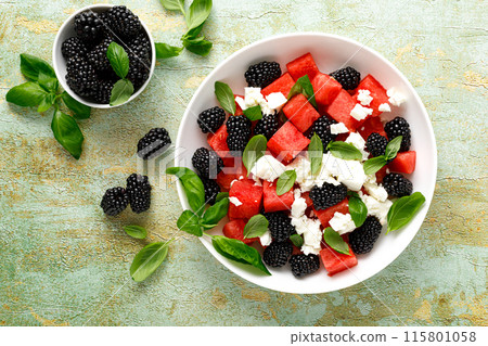 Watermelon salad with feta cheese, blackberry and fresh basil, top view Watermelon salad with feta cheese, blackberry and fresh basil, top view 115801058