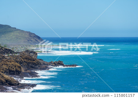 A scenic cliff by the ocean with waves crashing on the shore 115801157