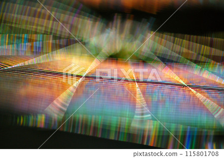 A spider web shining with rainbow colors in the morning sun A spider web shining with rainbow colors in the morning sun 115801708