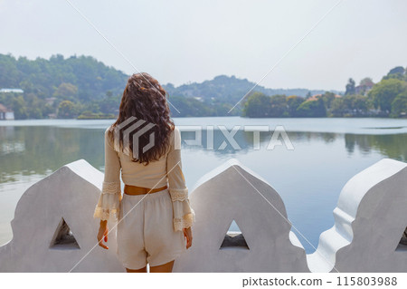 Woman Enjoying Serene Lake View in Kandy, Sri Lanka 115803988