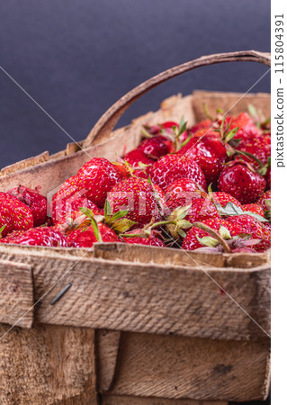 ripe strawberries in a wooden box on the table close up ripe strawberries in a wooden box on the table close up 115804391