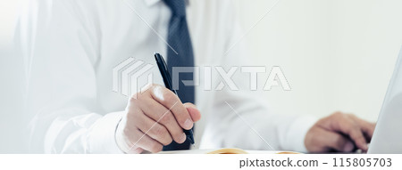 Hand of a man working on a laptop Hand of a man working on a laptop 115805703