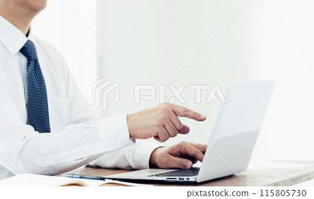 Hand of a man working on a laptop 115805730