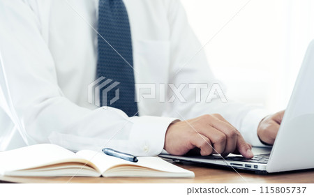 Hand of a man working on a laptop Hand of a man working on a laptop 115805737