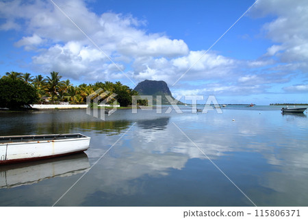 The Lady of the Indian Ocean, Mauritius: A view of the lagoon's water reflection and Mount Le Morne from the pier of Lagoletto, a town on the southwest coast The Lady of the Indian Ocean, Mauritius: A view of the lagoon's water reflection and Mount Le Morne from the pier of Lagoletto, a town on the southwest coast 115806371