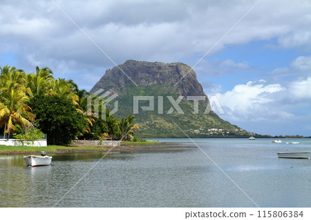 The Lady of the Indian Ocean, Mauritius: A view of the lagoon's water reflection and Mount Le Morne from the pier of Lagoletto, a town on the southwest coast The Lady of the Indian Ocean, Mauritius: A view of the lagoon's water reflection and Mount Le Morne from the pier of Lagoletto, a town on the southwest coast 115806384