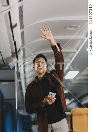 Low Section of Passenger Businessman Walking with Suitcase at the Entrance Walkway in Airport. Focus on Luggage. Low Angle View Low Section of Passenger Businessman Walking with Suitcase at the Entrance Walkway in Airport. Focus on Luggage. Low Angle View 115807510