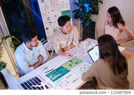 diversity team discusstion about esg and eco friendly system planning in sustainable green office at night 115807909