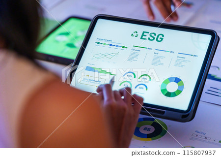 ESG ( environment, social,governance) recycle sign on laptop screen with carbon free chart board in office ESG ( environment, social,governance) recycle sign on laptop screen with carbon free chart board in office 115807937