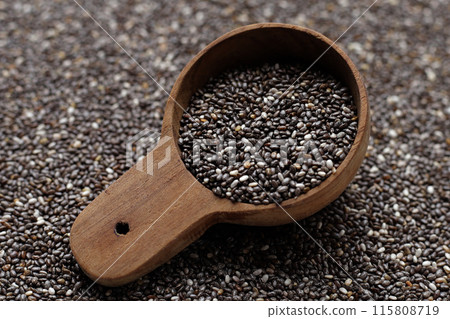 Chia seeds in wooden spoon Chia seeds in wooden spoon 115808719