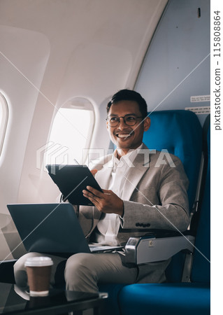 Airplane, travel and portrait of businessman working on laptop computer and smartphone while sitting in airplane. Airplane, travel and portrait of businessman working on laptop computer and smartphone while sitting in airplane. 115808864