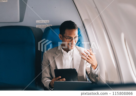 Airplane, travel and portrait of businessman working on laptop computer and smartphone while sitting in airplane. Airplane, travel and portrait of businessman working on laptop computer and smartphone while sitting in airplane. 115808866