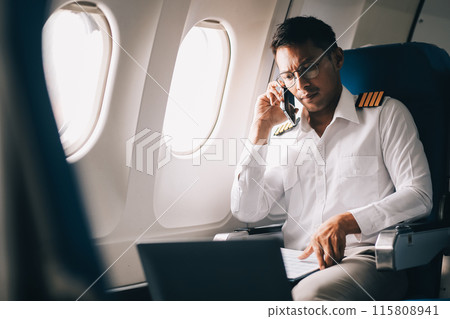 .Portrait of a trained airplane captain in uniform preparing to fly in a simulator cockpit. .Portrait of a trained airplane captain in uniform preparing to fly in a simulator cockpit. 115808941