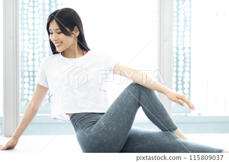 Portrait of a woman stretching (white short-sleeved fitness wear and long black hair) Portrait of a woman stretching (white short-sleeved fitness wear and long black hair) 115809037