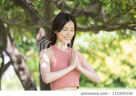 Woman doing yoga in green park (outdoor portrait, hands together in prayer, concentration, relaxation) Woman doing yoga in green park (outdoor portrait, hands together in prayer, concentration, relaxation) 115809190