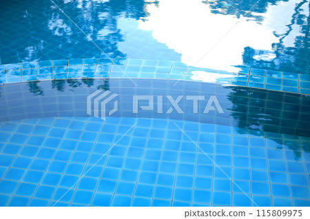 Blue water and ceramic tiles in swimming pool outdoor in garden of resort and hotel 115809975