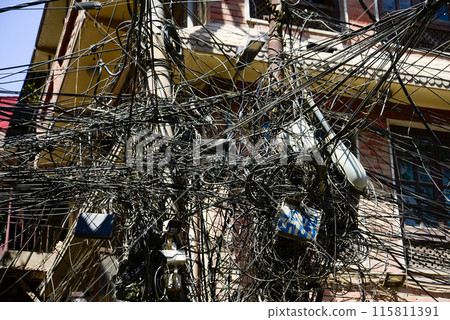 A scene of cables tangled around a utility pole in Nepal A scene of cables tangled around a utility pole in Nepal 115811391