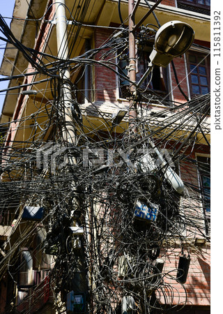 A scene of cables tangled around a utility pole in Nepal 115811392