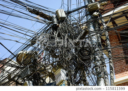 A scene of cables tangled around a utility pole in Nepal 115811399