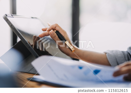 Portrait of Asian young female working on laptop and financial report at office. 115812615