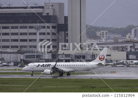 Passenger plane, airplane, J-AIR Embraer 190 landing at Osaka Airport and Itami Airport in the rain 115812904