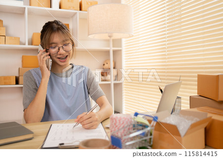 Sell products online, Business owner on the phone talking to a customer, Packaging and Delivery, Packaging and Shipping. 115814415