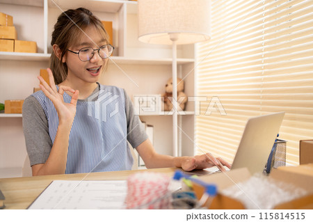 Sell products online, Young women are doing live or video calls with customers to place orders and prepare for delivery, Make The Ok Hand Sign to confirm and accept the order. 115814515