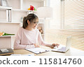Young woman using a laptop, Work from the comfort of home, Use your laptop for work and communication, Work from home. 115814760