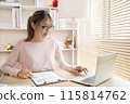 Young woman using a laptop, Work from the comfort of home, Use your laptop for work and communication, Work from home. 115814762
