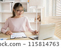 Young woman using a laptop, Work from the comfort of home, Use your laptop for work and communication, Work from home. 115814763