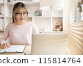 Young woman using a laptop, Work from the comfort of home, Use your laptop for work and communication, Work from home. 115814764