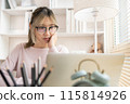 Young woman using a laptop, Work from the comfort of home, Use your laptop for work and communication, Work from home. 115814926