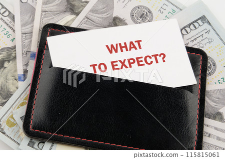 Business concept. WHAT TO EXPECT text on a business card in a black leather accessory against the background of American dollars 115815061