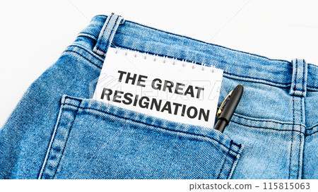 Text THE GREAT RESIGNATION on a notebook on jeans on a white background Text THE GREAT RESIGNATION on a notebook on jeans on a white background 115815063