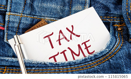 Business and tax concept. TAX TIME on a piece of paper from a jeans pocket Business and tax concept. TAX TIME on a piece of paper from a jeans pocket 115815065