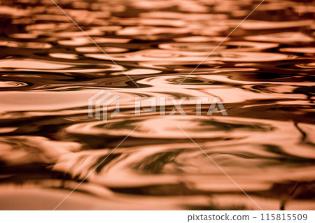 A image of golden ocean waves featuring a water surface in detail A image of golden ocean waves featuring a water surface in detail 115815509