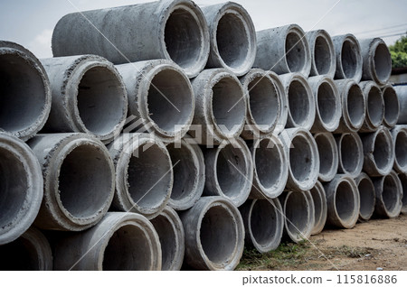 A stack of concrete ring pipes piled and creating a symmetrical arrangement A stack of concrete ring pipes piled and creating a symmetrical arrangement 115816886