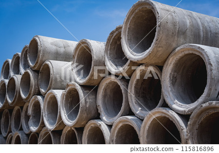 A stack of concrete ring pipes piled and creating a symmetrical arrangement A stack of concrete ring pipes piled and creating a symmetrical arrangement 115816896