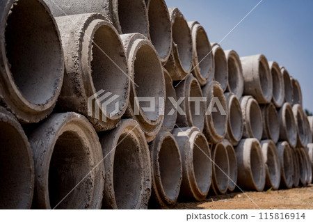 A stack of concrete ring pipes piled and creating a symmetrical arrangement 115816914