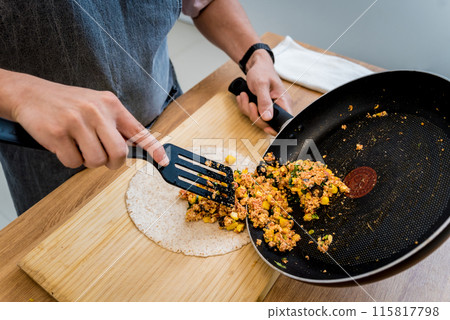 Chef at the kitchen preparing quesadillas with tofu and sweet corn 115817798
