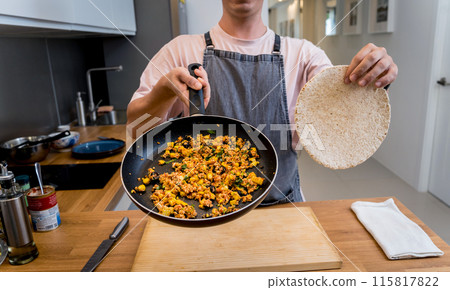 Chef at the kitchen preparing quesadillas with tofu and sweet corn Chef at the kitchen preparing quesadillas with tofu and sweet corn 115817822
