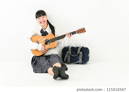 School girls playing the guitar 115818567