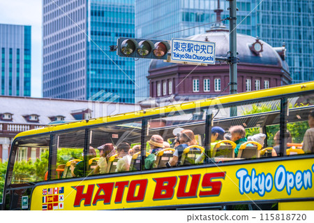 Tokyo cityscape in Japan Inbound tourism revival (bustling Tokyo Station area). Tokyo Station central exit and buses with foreign tourists boarding Tokyo cityscape in Japan Inbound tourism revival (bustling Tokyo Station area). Tokyo Station central exit and buses with foreign tourists boarding 115818720