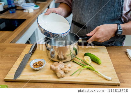 Chef at the kitchen preparing rice porridge with onion and sesame seeds Chef at the kitchen preparing rice porridge with onion and sesame seeds 115818738