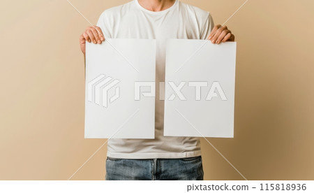Man presenting two blank poster mockups against a neutral background 115818936
