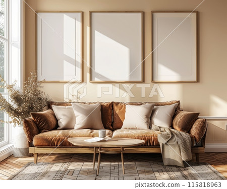 Cozy living room with brown leather sofa and three blank picture frames on wall 115818963